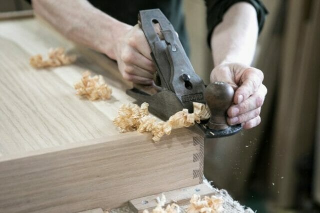 Traditional woodworking process at Higham Furniture, refining timber by hand for a handmade kitchen