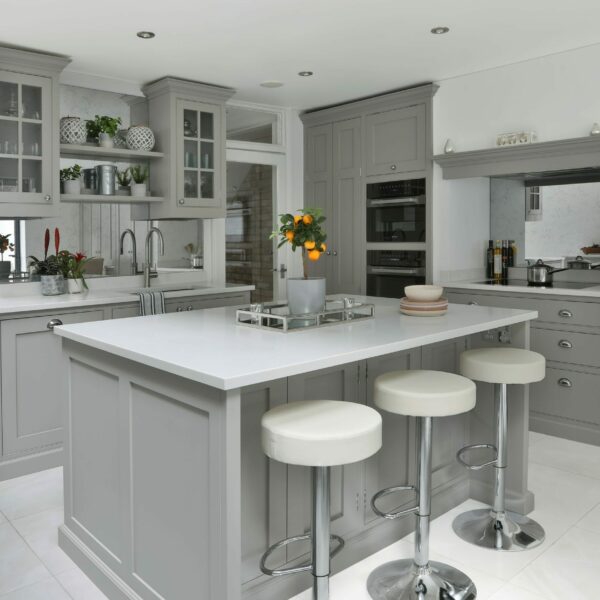 Clapham Painted Shaker Kitchen with a central island, dressers, glazed wall cabinets, integrated fridge freezer, and an induction hob built into a chimney