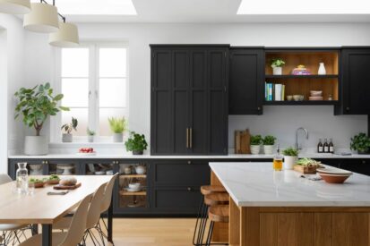 Black Shaker kitchen with a bi-fold dresser, oak island and oak carcasses, glass-fronted base cabinets.