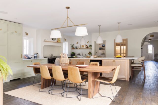 Open-plan luxury kitchen and dining space with bespoke cabinetry and natural materials