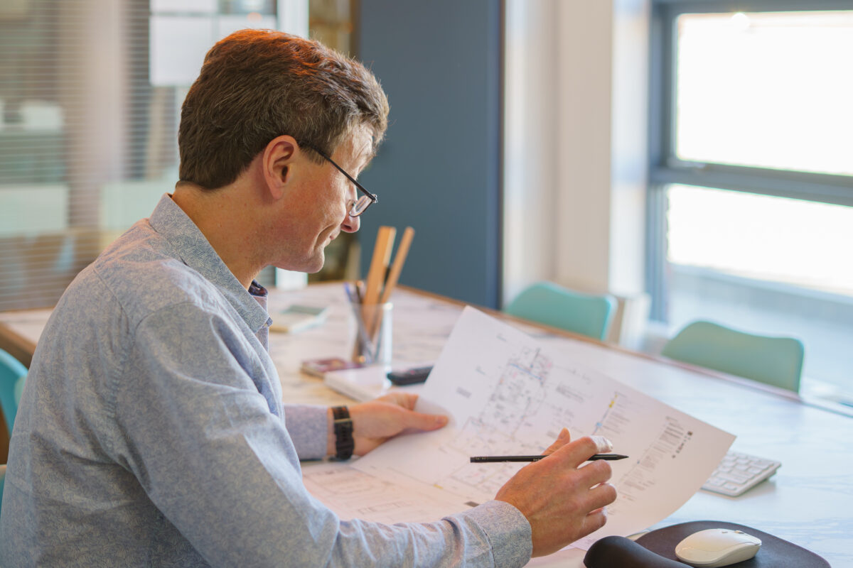 Bespoke kitchen design process at Higham Furniture Fulham studio with designer reviewing plans