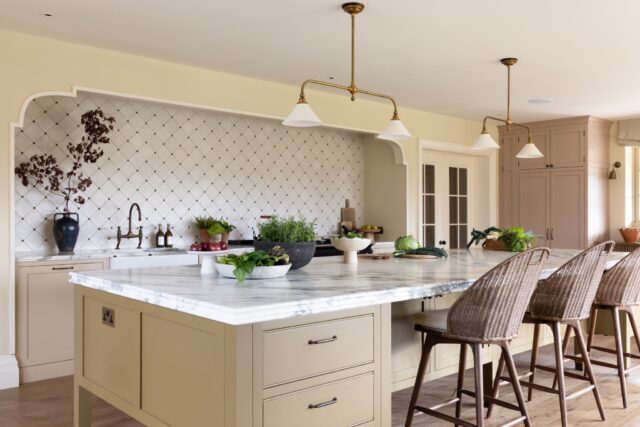Traditional shaker kitchen with marble island and brass pendant lighting