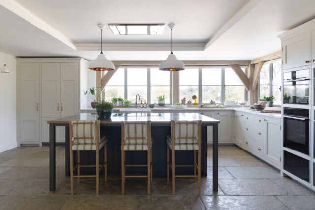 Classic shaker kitchen with central island, bar stools and countryside views